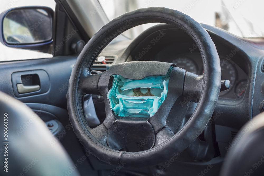 The exploded airbag on the steering wheel The exploded airbag on the steering wheel