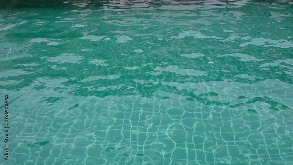 young woman relaxing and slowly swims in swimming pool. concept of summer holidays young woman relaxing and slowly swims in swimming pool. concept of summer holidays