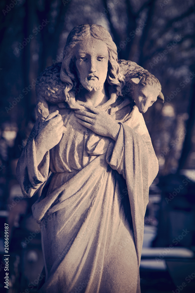 Retro and  dirty styled image of antique statue Jesus Christ Good Shepherd