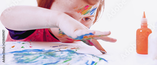 Great artist. Humorous photo of cute little child girl painting a picture (talent, art, creativity concept)