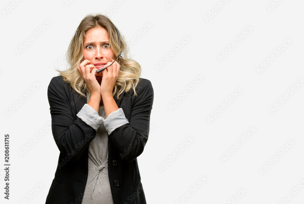 Young woman operator from call center terrified and nervous expressing anxiety and panic gesture, overwhelmed Young woman operator from call center terrified and nervous expressing anxiety and panic gesture, overwhelmed