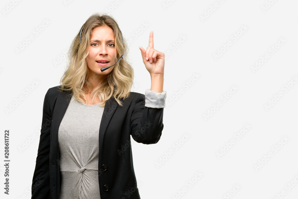 Young woman operator from call center happy and surprised cheering expressing wow gesture pointing up Young woman operator from call center happy and surprised cheering expressing wow gesture pointing up