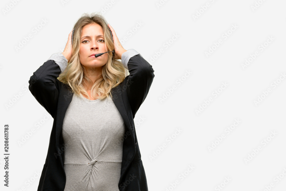 Young woman operator from call center covering ears ignoring annoying loud noise, plugs ears to avoid hearing sound. Noisy music is a problem. Young woman operator from call center covering ears ignoring annoying loud noise, plugs ears to avoid hearing sound. Noisy music is a problem.