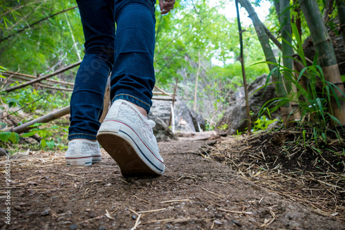 woman's feet walking in nature trail