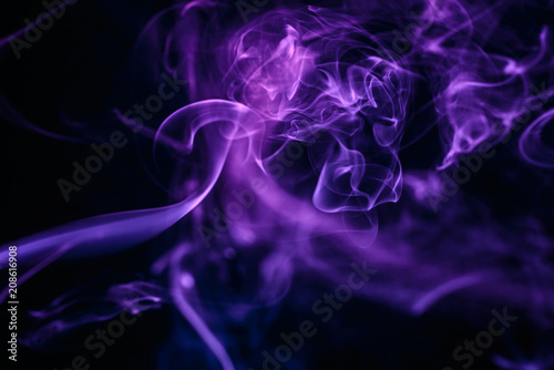 Abstract smoke on black background. Colored fume swirls.
