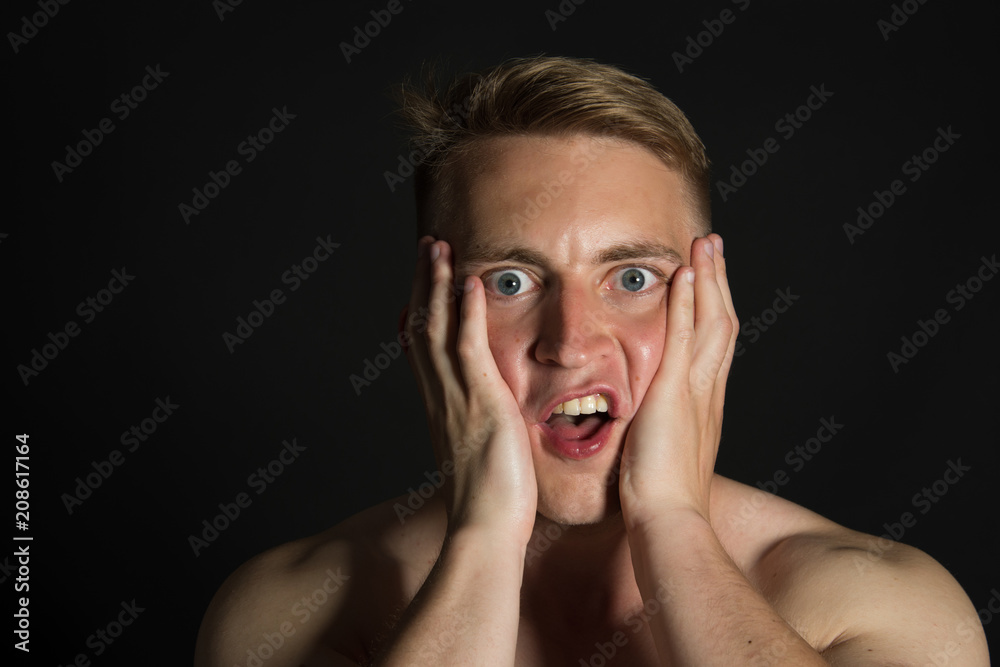 Fright and surprise. Funny guy. Black background.