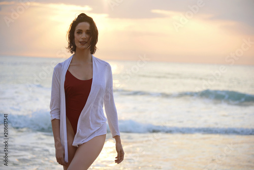 beautiful woman portrait in fashion swimsuit at sunset on the sea