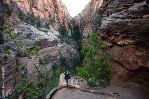 A man with his baby boy are trekking in Zion national park, Utah, USA