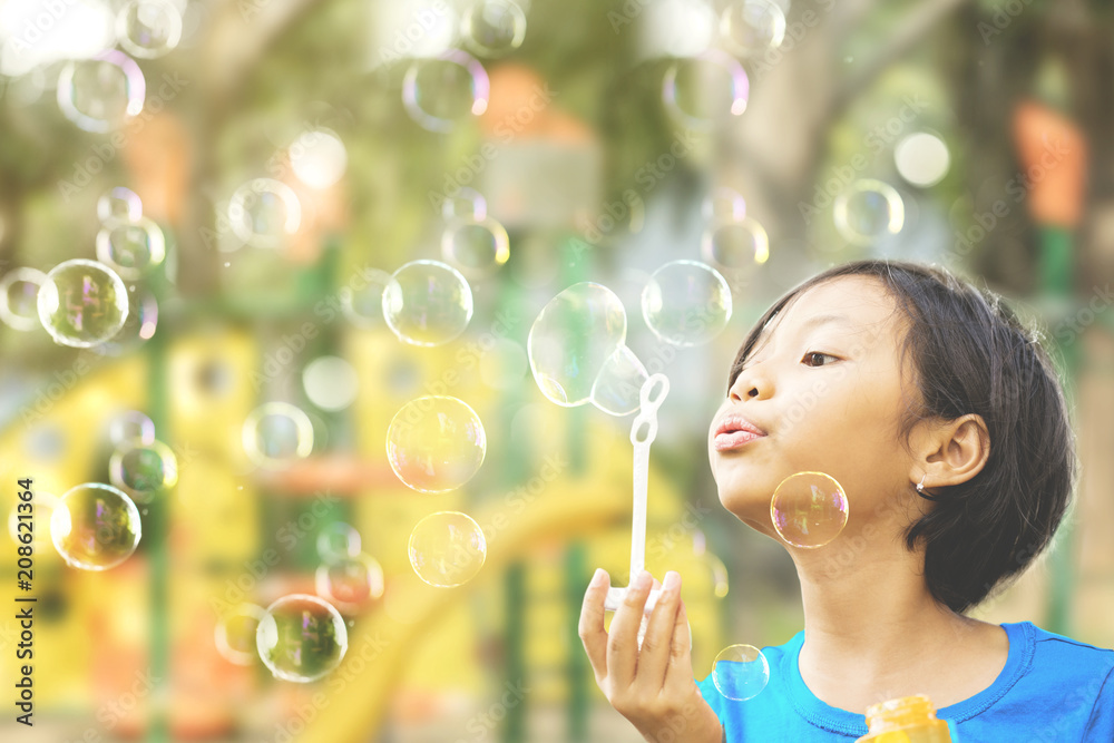 Pretty little girl playing with soap bubbles Pretty little girl playing with soap bubbles