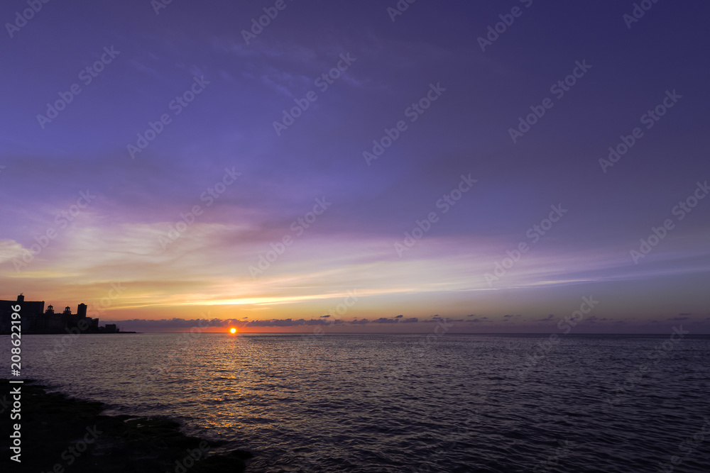 Sunset over Malecon and Atlantic Ocean with Morro Castle in background - Havana, Cuba 