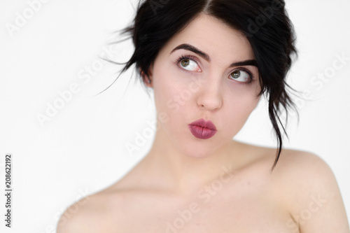 emotion face. playful coquettish naughty frolicsome flippant childish woman. pin up style pout. young beautiful brunette girl portrait on white background. photo