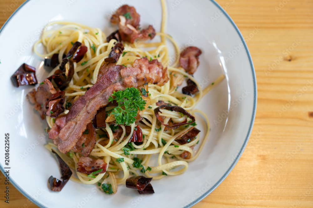 Delicious spaghetti with bacon on wooden table Delicious spaghetti with bacon on wooden table