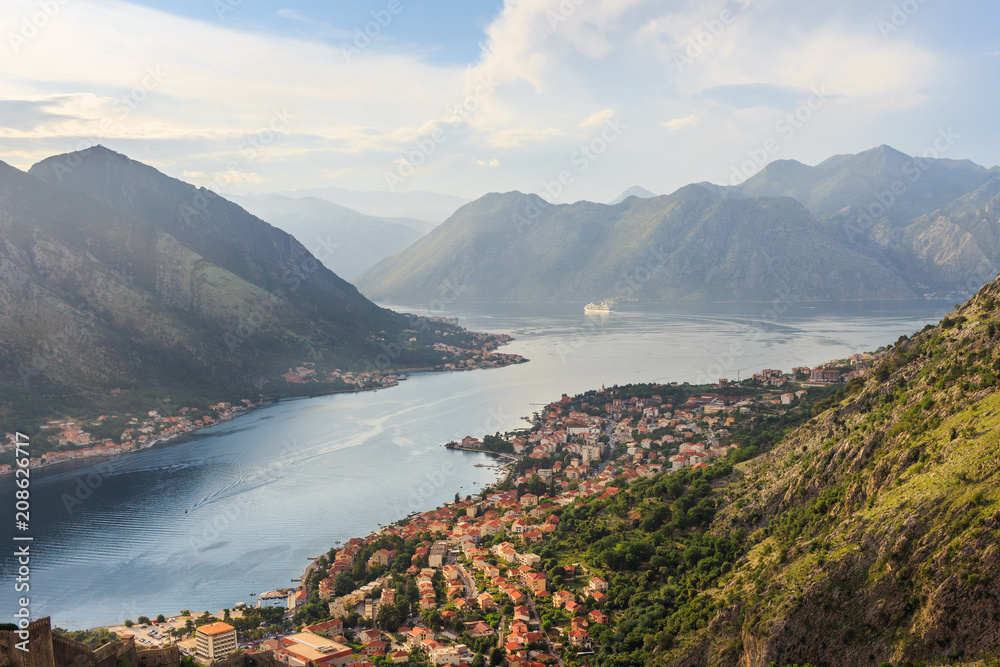 Obraz premium Panoramic view from above on the old city Kotor, bay in Adriatic sea and mountains in Montenegro at sunset time, gorgeous nature landscape