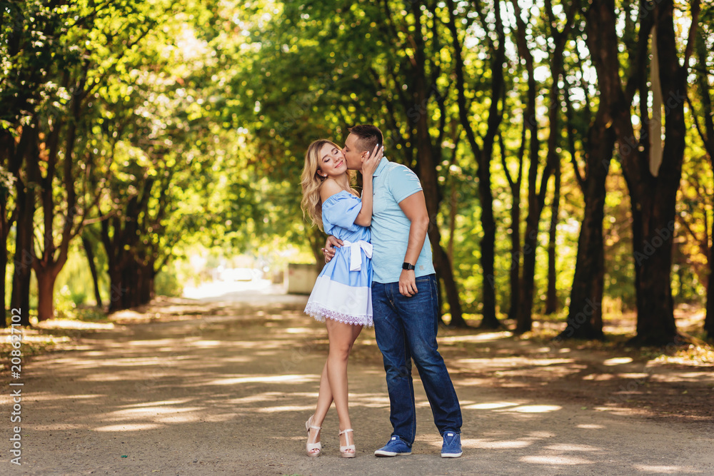 Beautiful couple taking a walk in city park Beautiful couple taking a walk in city park
