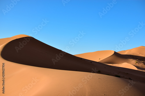 Sands, dunes and shadows in the Sahara desert. Photograph taken somewhere in the Sahara desert in Merzouga (Morocco)