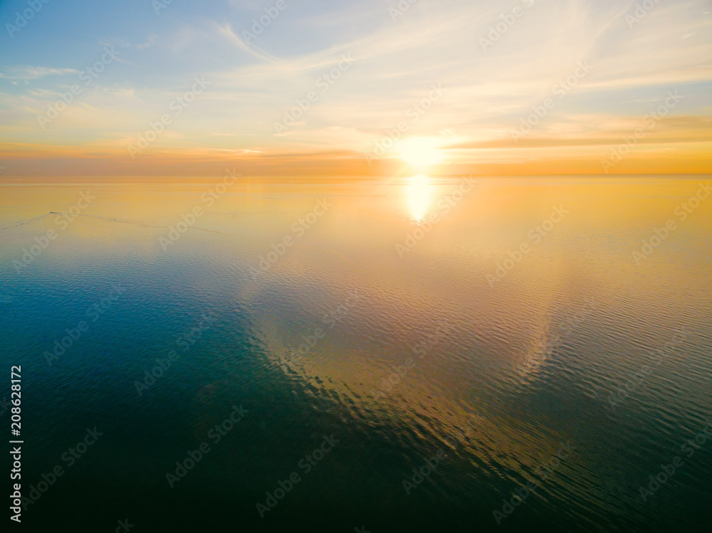 Nothing but sun and calm ocean water at sunset