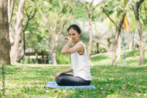 Photos Young asian woman yoga outdoors keep calm and meditates while practicing yoga to explore the inner peace
