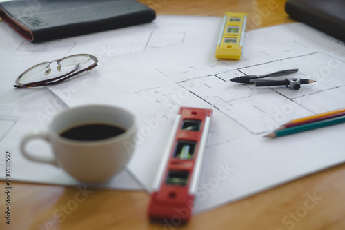 Architectural plans work space top view. Architectural project, blueprints,pencil and divider compass on wooden desk table.Construction background.Engineering tools. Copy space.Architectural Concept