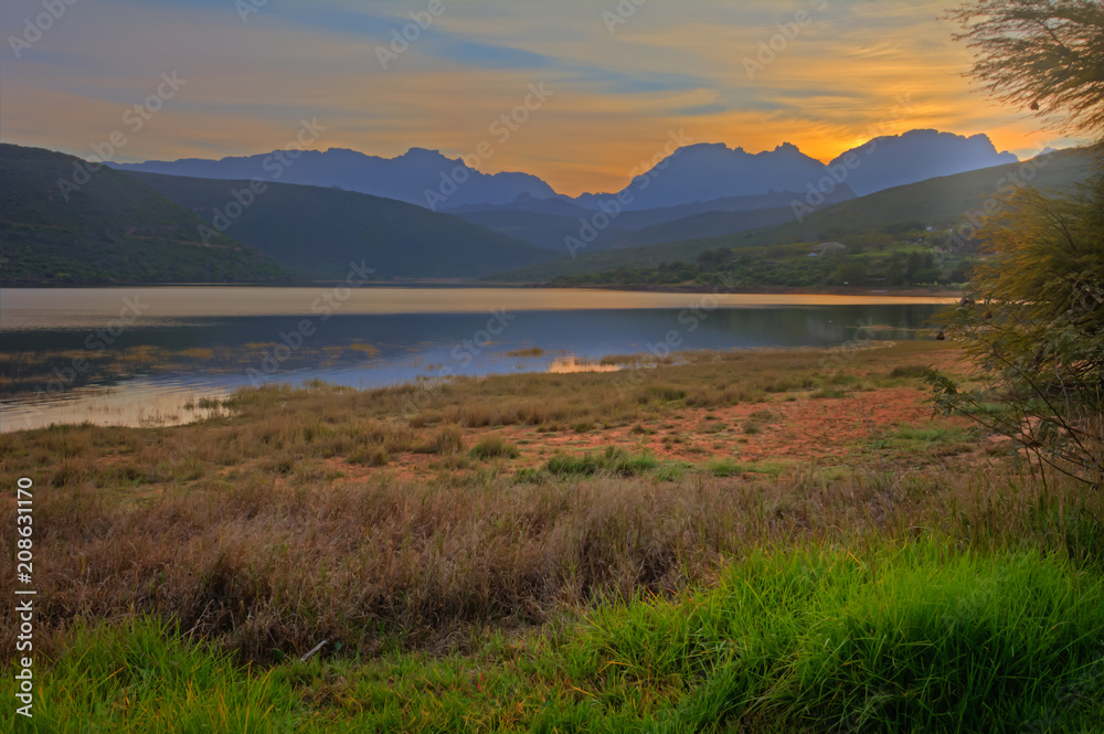 Dawn over lake with blue mountains Dawn over lake with blue mountains