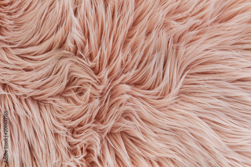 Pink synthetic fluffy fur texture background photo
