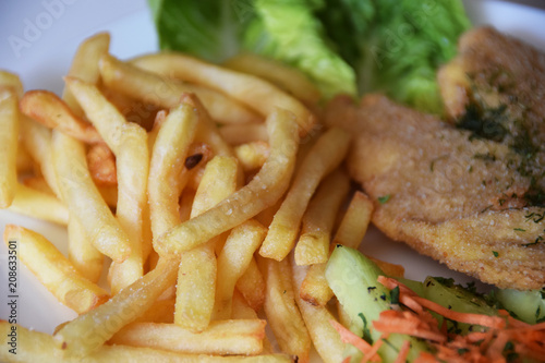fries and a salad of fresh cucumber and grated carrot fried fish