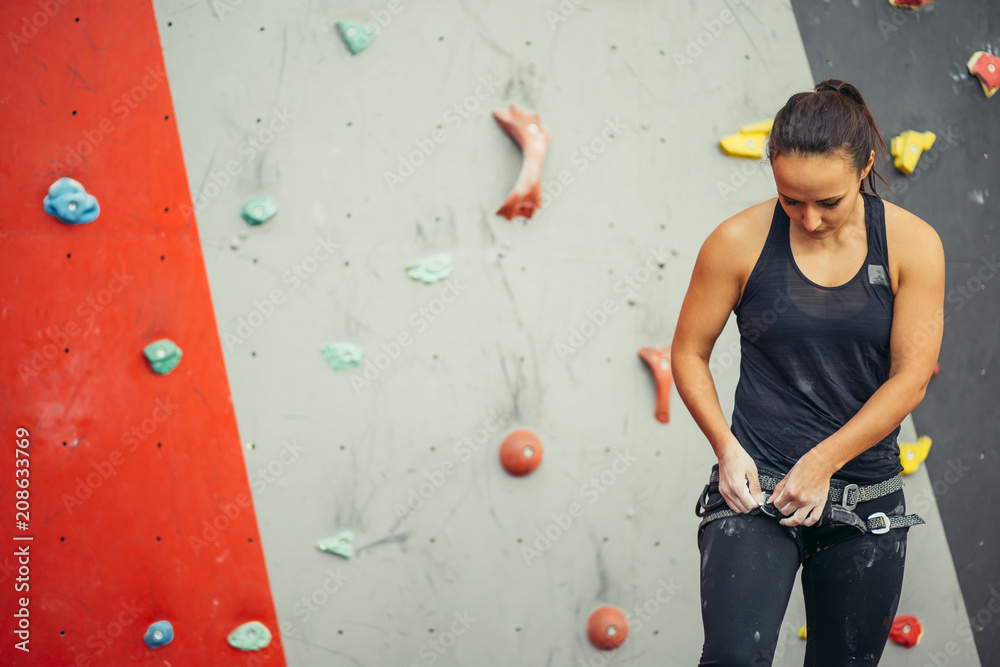 Rock climbing instructor female demonstrating how to tie the figure