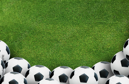 Framing background of soccer football ball on green grass of soccer field.