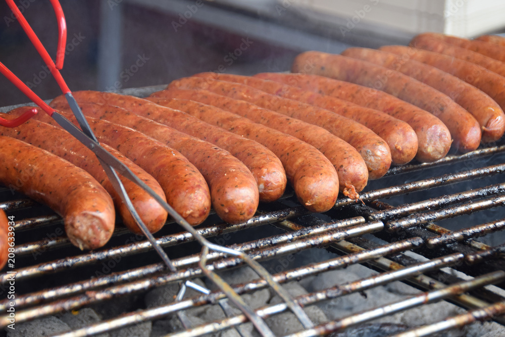 sausages fried on the grill at the market stall during the festivity