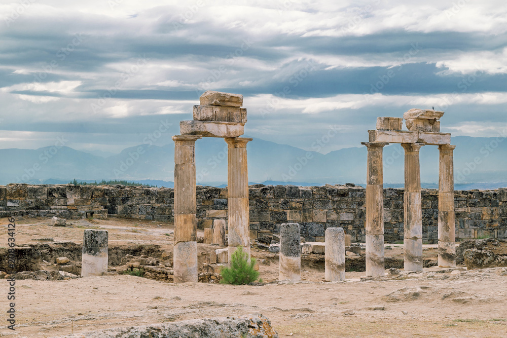 Fototapeta premium The ancient destroyed city of Hierapolis near Pamukkale, Denizli, Turkey in the summer. On a background the sky in overcast. Horizontal orientation