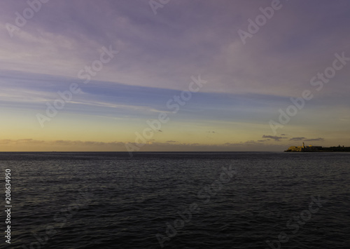 Sunset over Malecon and Atlantic Ocean with Morro Castle in background - Havana, Cuba  © Marcin