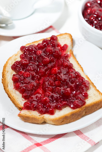 toast with cranberry jam for sweet breakfast, vertical top view