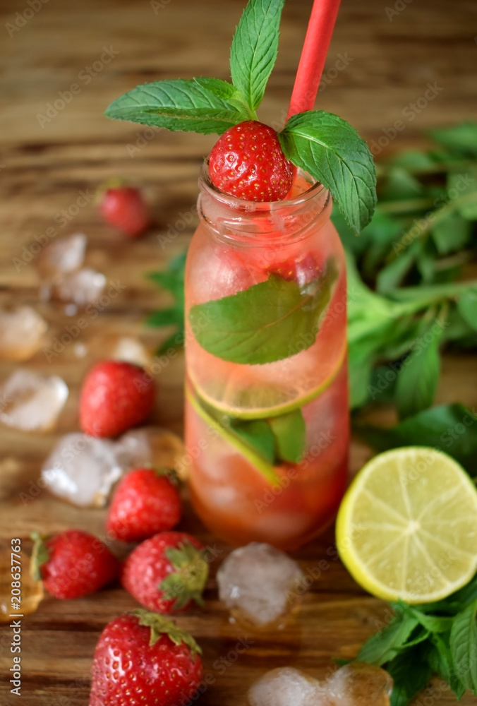 Lemonade with strawberry, lime, ice cubes and mint in a glass bottle Lemonade with strawberry, lime, ice cubes and mint in a glass bottle