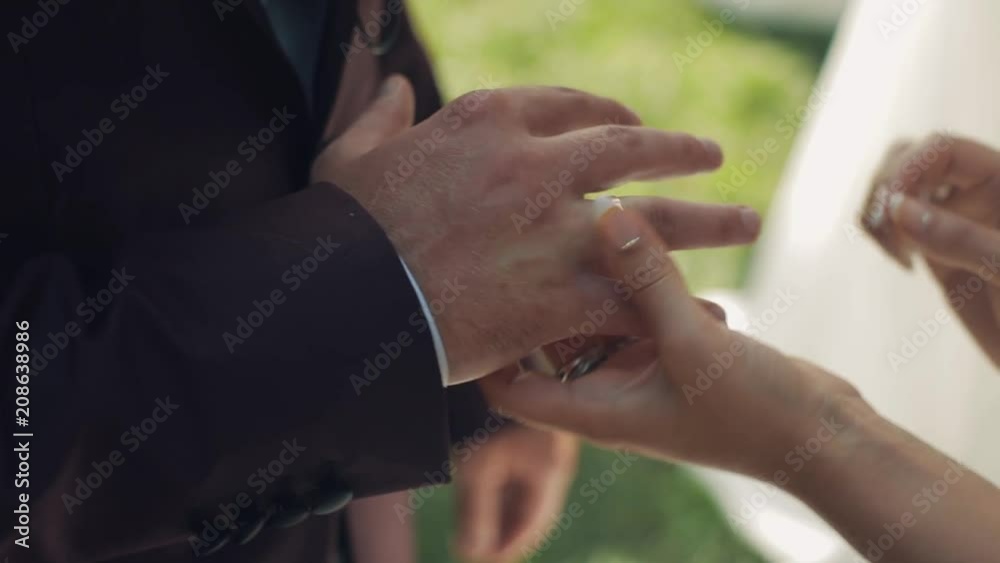 The bride puts on the wedding ring to the groom The bride puts on the wedding ring to the groom