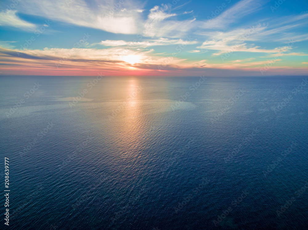 Minimalist seascape sunset - sun setting over tranquil sea