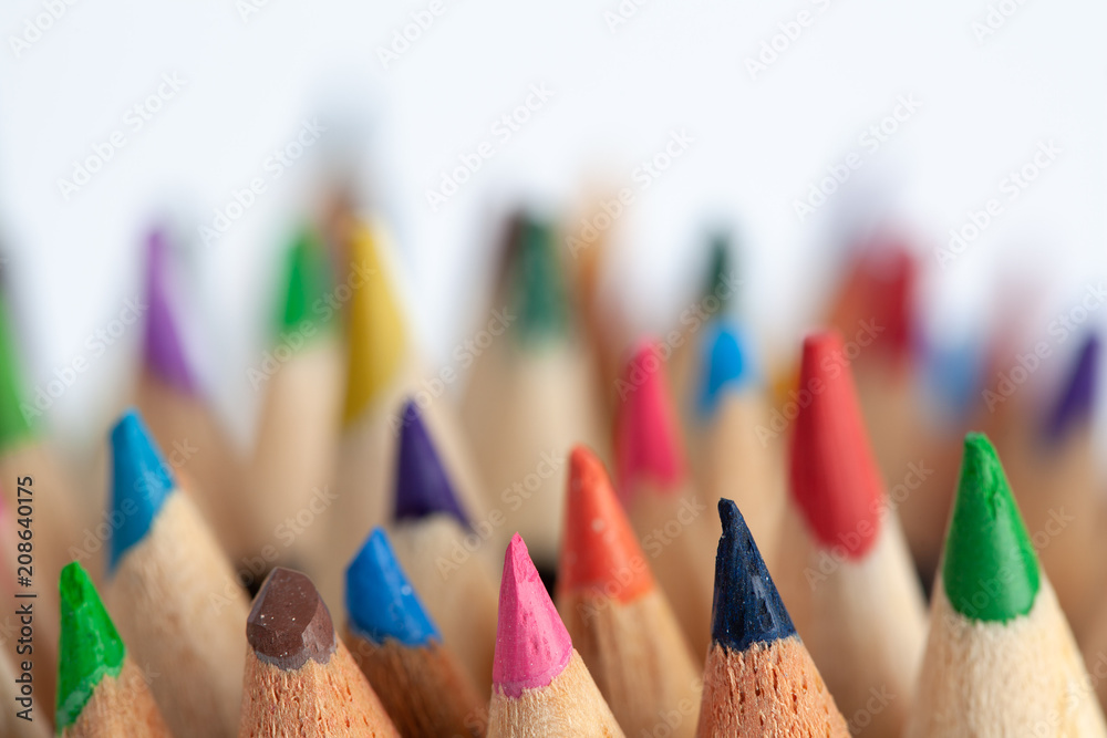 Bunch of colored pencils on white background with focus on foreground and shallow depth of field - art and creativity concept Bunch of colored pencils on white background with focus on foreground and shallow depth of field - art and creativity concept