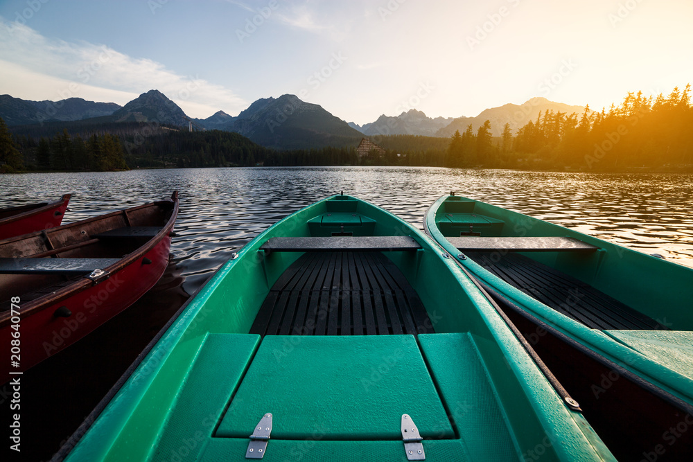 Stunning mountain lake with colorful wooden boat. National Park High Tatras, Strbske Pleso, Slovakia, Europe