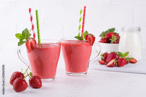 Strawberry smoothie or milkshake in glass cup. Healthy food for breakfast and snack