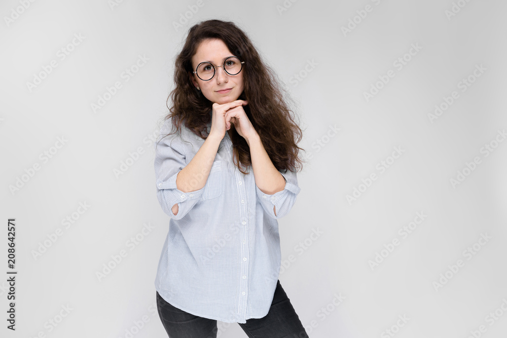 Young brunette girl with glasses. The girl propped her chin on her hands. Young brunette girl with glasses. The girl propped her chin on her hands.