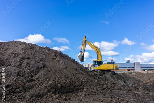 excavator digs the earth