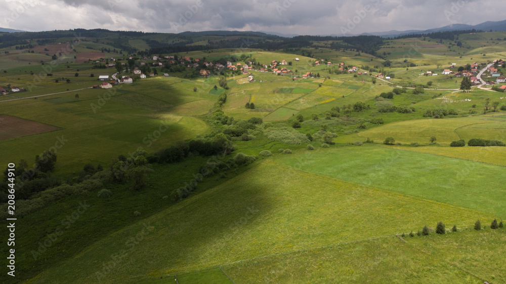 small villages in distance with green fields in front small villages in distance with green fields in front