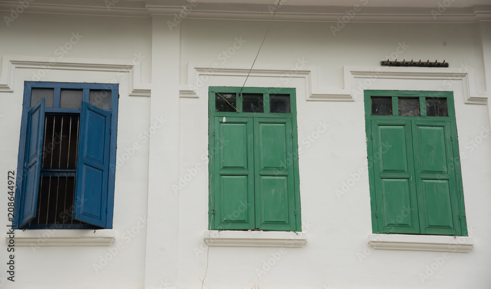 Fototapeta premium Three windows on a white ancient building