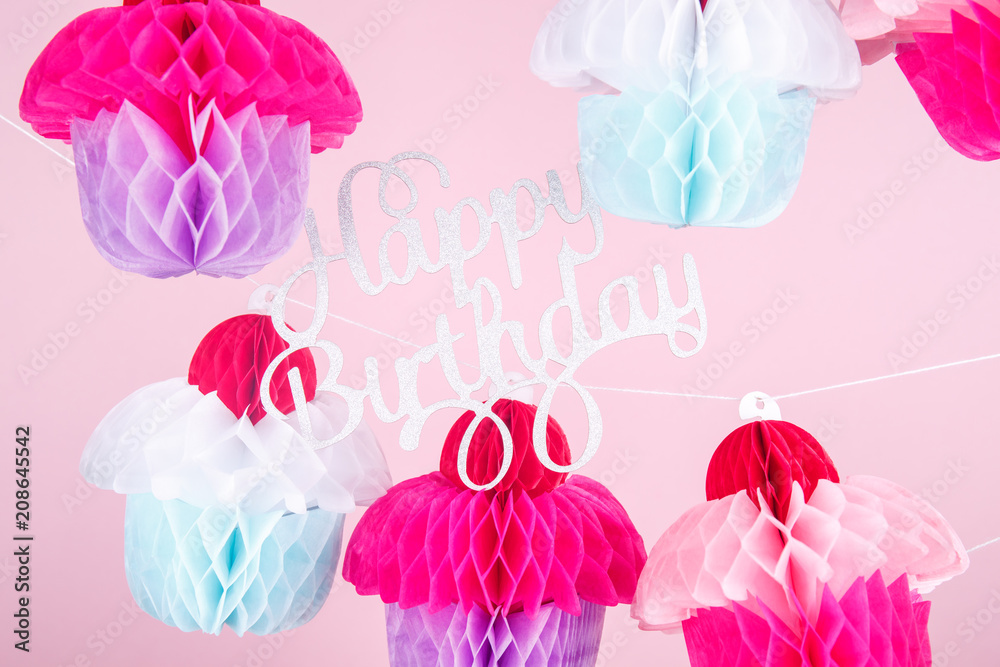 Paper cupcakes celebration decoration with happy birthday lettering. Holiday party concept Paper cupcakes celebration decoration with happy birthday lettering. Holiday party concept