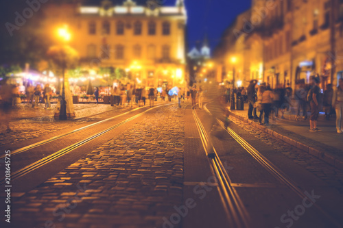 Photography A crowd of people moving on the old european city night street defocused blurred