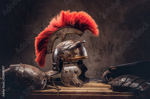 Fototapeta Complete combat equipment of the ancient Greek warrior lie on a box of wooden boards