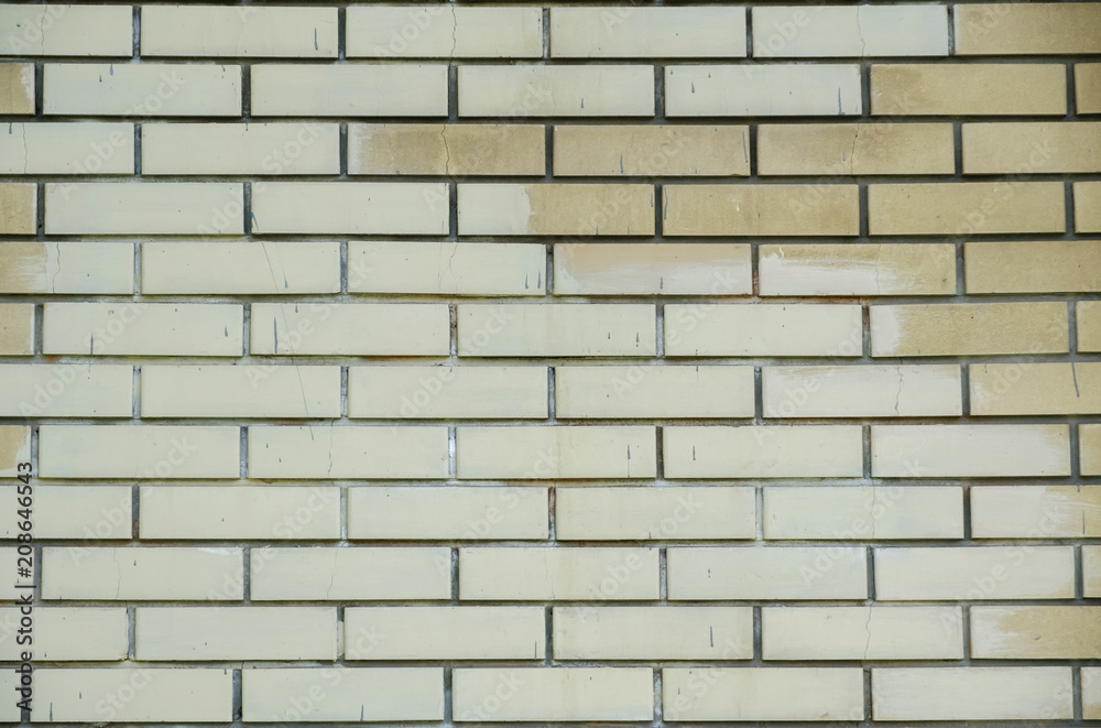 Brick wall texture of yellow stone blocks closeup abstract background