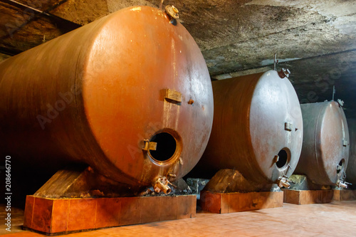 Large storage tanks where grape juice is aged into wine located in a wine cellar