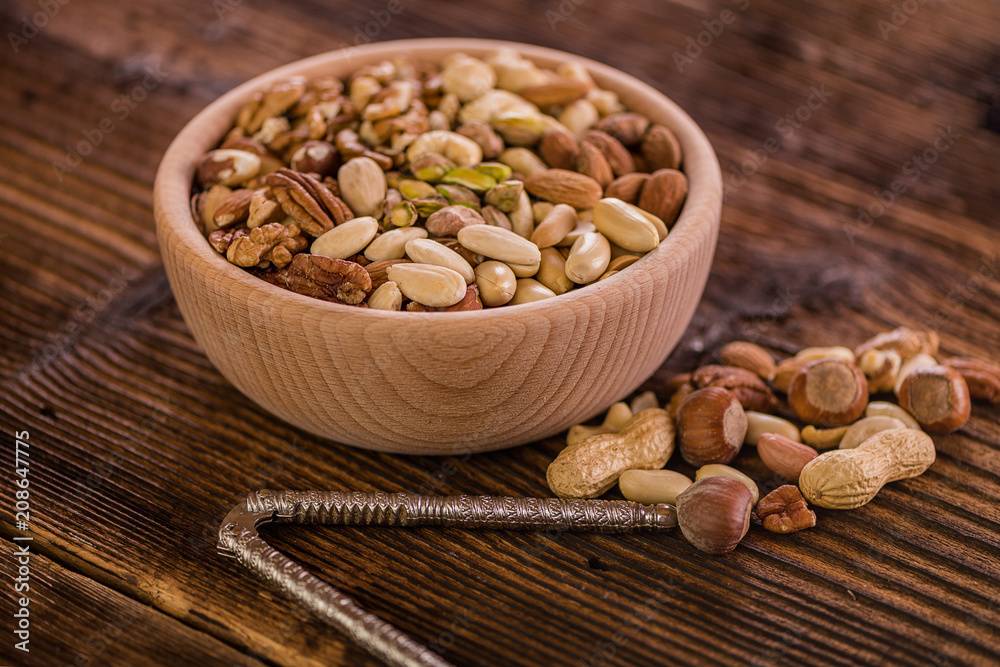 wooden bowl full of different muxture variety of nuts wooden bowl full of different muxture variety of nuts