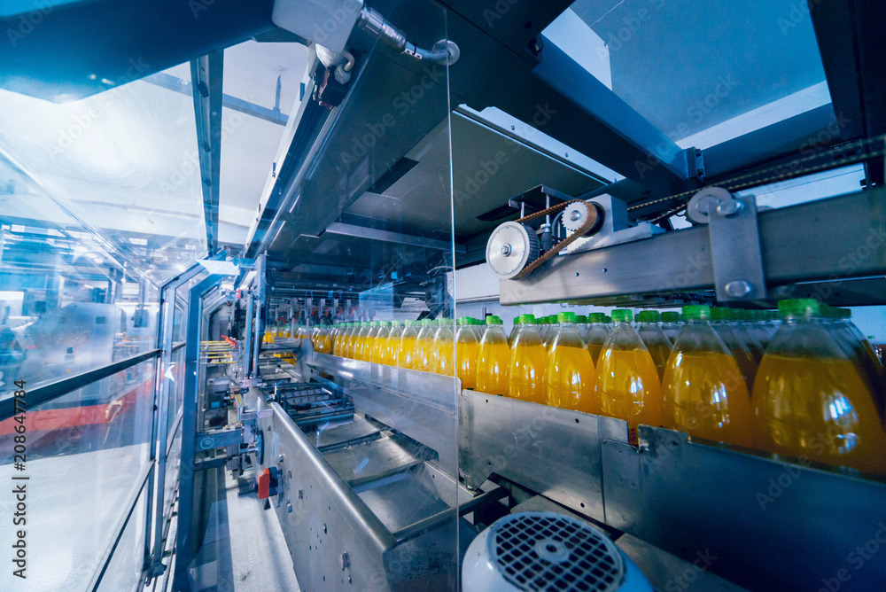 Beverage factory interior. Conveyor with bottles for juice or water. Equipments