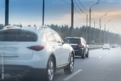 White and black Cars on the freezed road in winter.