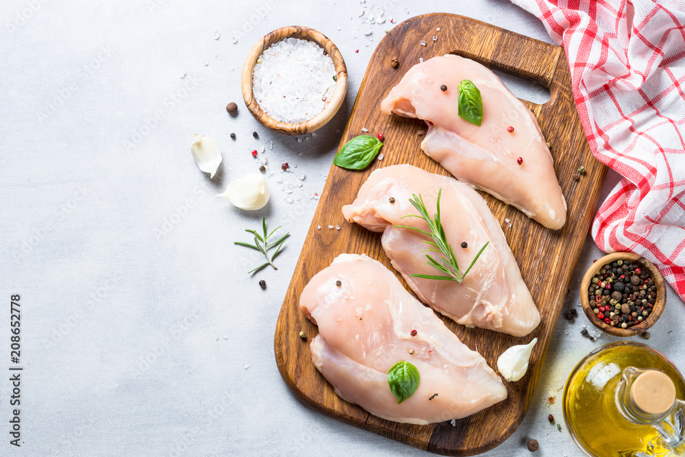 Raw chicken fillet with spices and herbs top view. Raw chicken fillet with spices and herbs top view.
